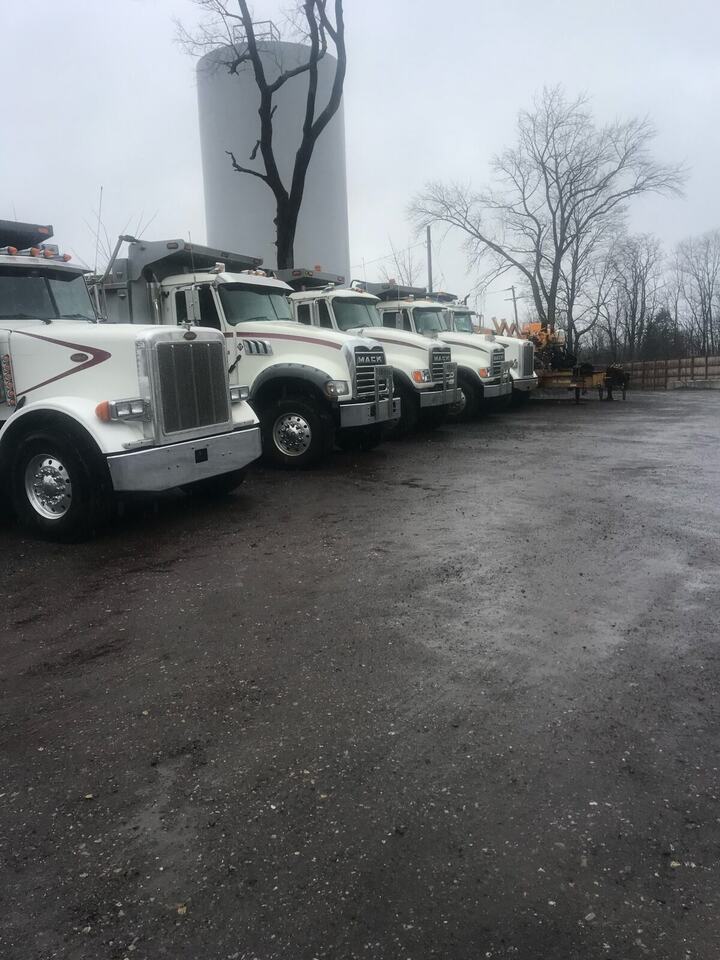 DeRosato Enterprises dump trucks lined up in the yard